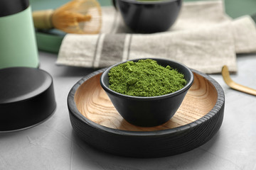 Bowl with powdered matcha tea on table