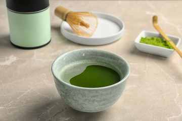 Chawan with fresh matcha tea on table