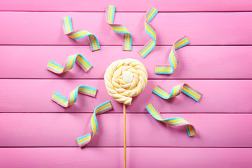 Colorful candies beautifully arranged on wooden background
