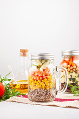 Fototapeta na wymiar Fresh homemade salad in jars with quinoa, chickpeas and organic vegetables. Healthy take away food, office lunch, vegeterian, detox diet concept.