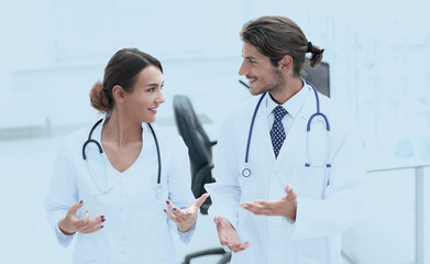 Fototapeta premium Two Doctors Having Meeting In Hospital Reception Area