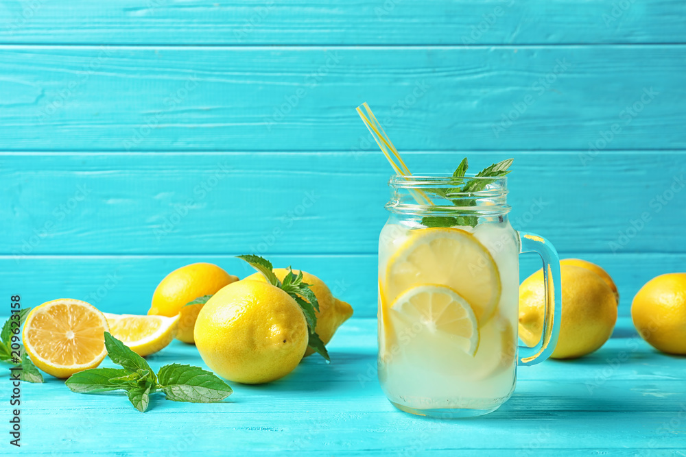 Wall mural Natural lemonade in mason jar on wooden table