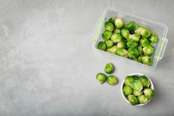 Flat lay composition with frozen brussel sprouts on light background. Vegetable preservation