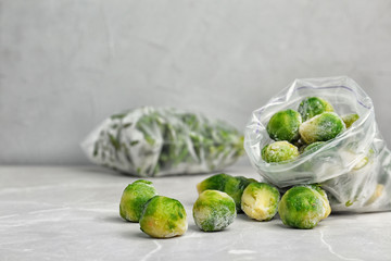 Plastic bag with frozen Brussel sprouts on table. Vegetable preservation