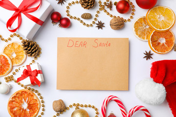 Flat lay composition with paper and Christmas decor on white background. Letter for Santa Claus