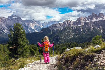 Fototapeta na wymiar little girl hiker on a path