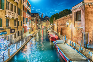 Fototapeta na wymiar View over a picturesque canal at night, Venice, Italy