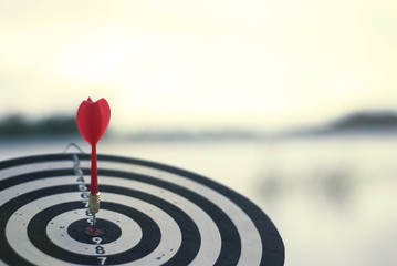 Shot red dart arrow in center of dartboard. Concept to target success and winner