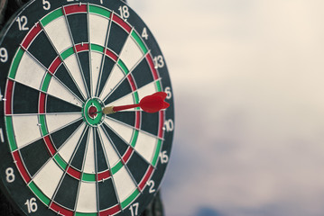 Shot red dart arrow in center of dartboard. Concept to target success and winner