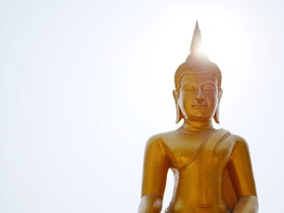 The Lord Buddha image / statue on bright sky and the sun - symbolizes the fact that he has entered the light and been the light for mankind