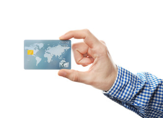 Young man holding credit card on white background