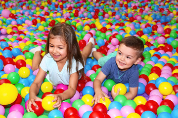 Fototapeta na wymiar Cute children playing among plastic balls