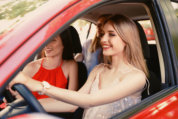 Happy beautiful young women together in car
