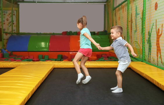 Cute children jumping on trampoline in entertainment center