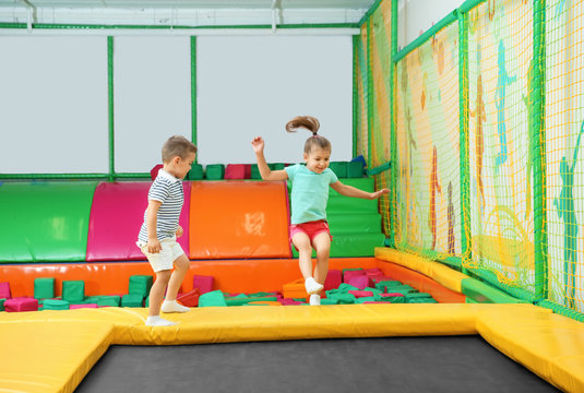Cute children playing on trampoline in entertainment center