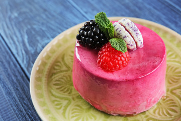 Tasty berry mousse cake on plate