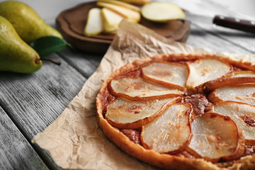 Delicious pear tart on table