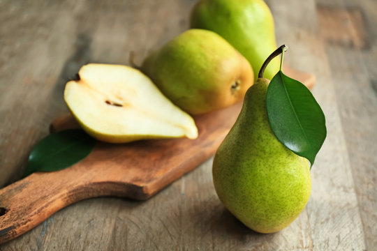 Delicious ripe pear on wooden table