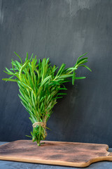 fresh bunch of rosemary on a wooden cutting board