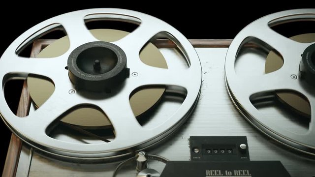 Reels of retro reel-to-reel magnetic tape recorder.  Vintage audio recorder.