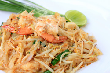 Thai style noodles, Pad Thai, stir-fried rice noodles with shrimp serve with vegetable in white plate on white background. The one of Thailand's national main dish. the popular food in Thailand.