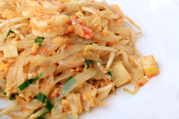 Thai style noodles, Pad Thai, stir-fried rice noodles with shrimp serve with vegetable in white plate on white background. The one of Thailand's national main dish. the popular food in Thailand.