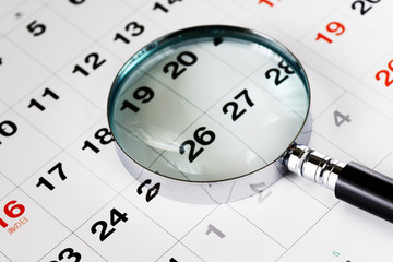 a magnifying glass on the calendar 