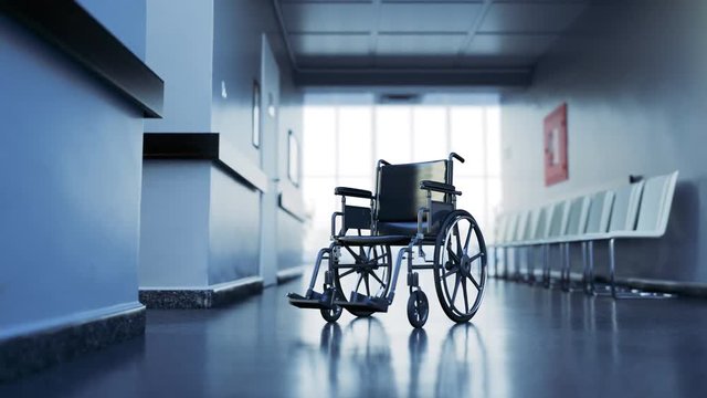 Abandoned wheelchair in empty, clean hospital waiting corridor. Disability in 4K