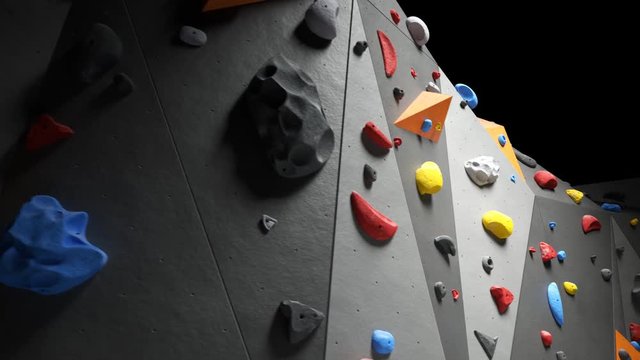 Indoor bouldering wall with colorful climbing holds. Gym indoor extreme training