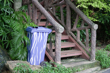 Blue Plastic Container or Recycle Bin near Old Stairs In The Park