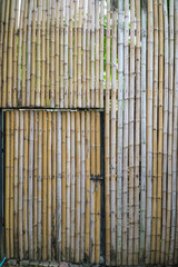 A handmade bamboo door on bamboo wall