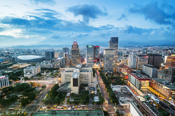 Asia Business concept for real estate and corporate construction - panoramic urban city skyline aerial view and tokyo station under twilight sky and neon night in Taipei, Taiwan