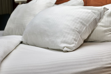 Fototapeta na wymiar White Down Pillows on a Bed