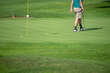 Golfer on the green, mature male, not recognizable, copyspace