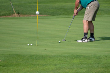 Golfer on the green, mature male, not recognizable, copyspace
