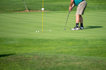 Obraz premium Golfer on the green, mature male, not recognizable, copyspace