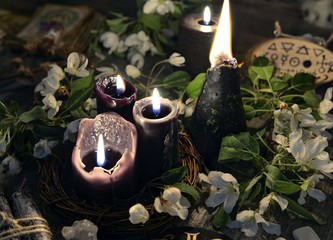 White flowers, black candles and mystic objects. Occult, esoteric and divination still life....