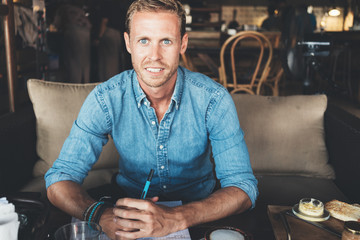 Portrait of handsome entrepreneur working on his project at street cafe