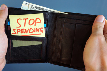 Hands holding wallet with stick Stop spending.