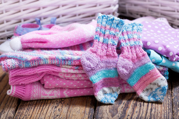 baby clothes on wooden table