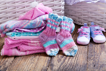 baby clothes on wooden table