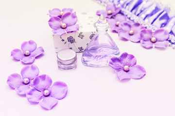 Naklejka na ściany i meble perfume bottle with a box and some purple and pink decorations on white background, woman cosmetics