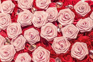 Wedding background with red and light pink silky roses, decoration of the wedding party