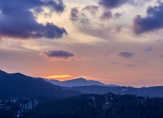 Spectacular sunset over mountain valley and small town
