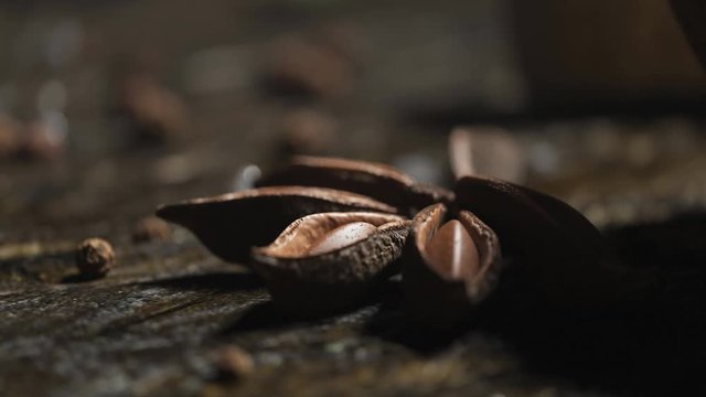 Anise and peppercorns on old wooden surface in kitchen used for spicing food. 4K