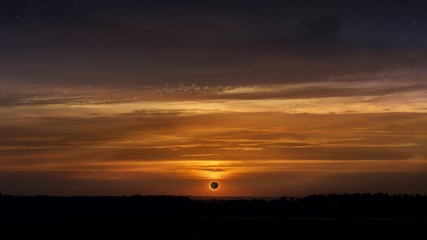 Solar Eclipse . Scientific natural phenomenon . Total solar eclipse with diamond ring effect glowing on sky . Serenity nature background . 