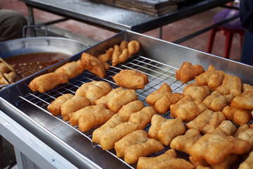 Chinese dough or deep fried dough in the stainless steel tray for sell in morning market of Thailand