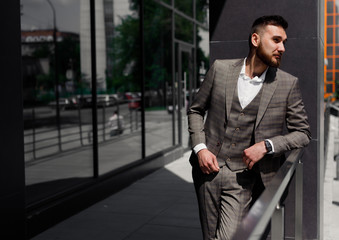 Businessman in city. Modern businessman. Confident young man in full suit standing outdoors