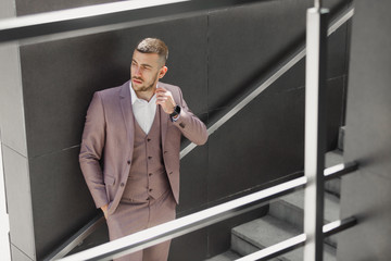 Businessman in city. Modern businessman. Confident young man in full suit standing outdoors