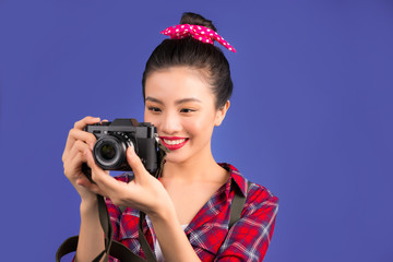 Woman travel. Young beautiful asian woman traveler taking pictures on blue background